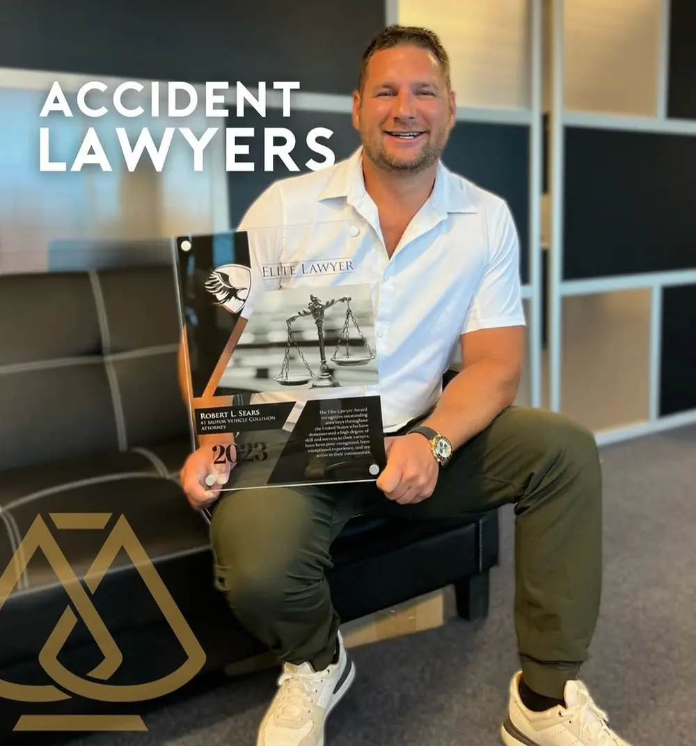 Robert Sears holding an Elite Lawyer recognition plaque