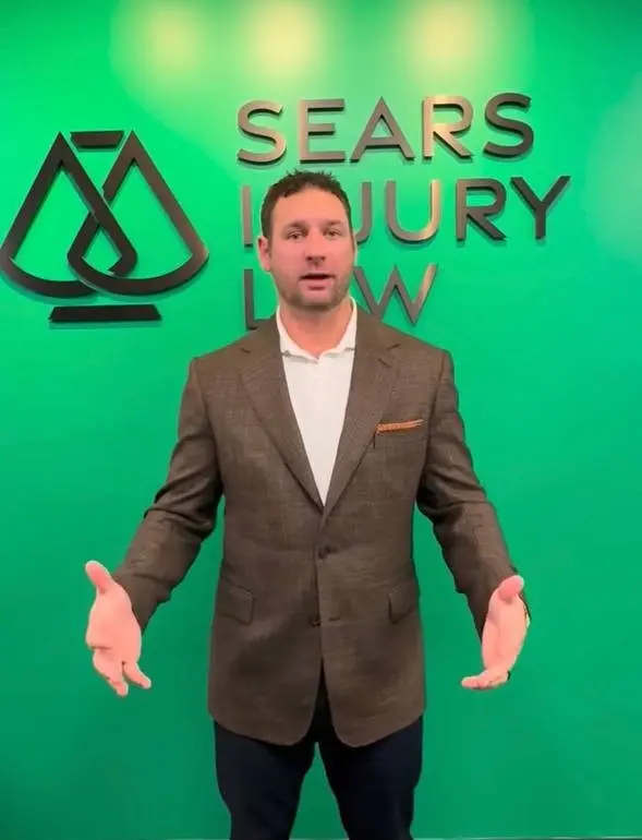 Robert Sears standing in front of Sears Injury Law branding