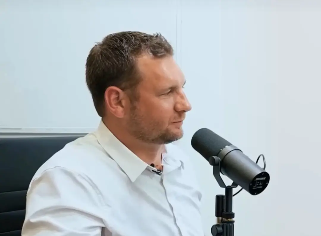 Robert Sears speaking into a studio microphone
