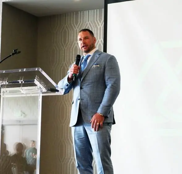 Robert Sears speaking at a lectern with a microphone