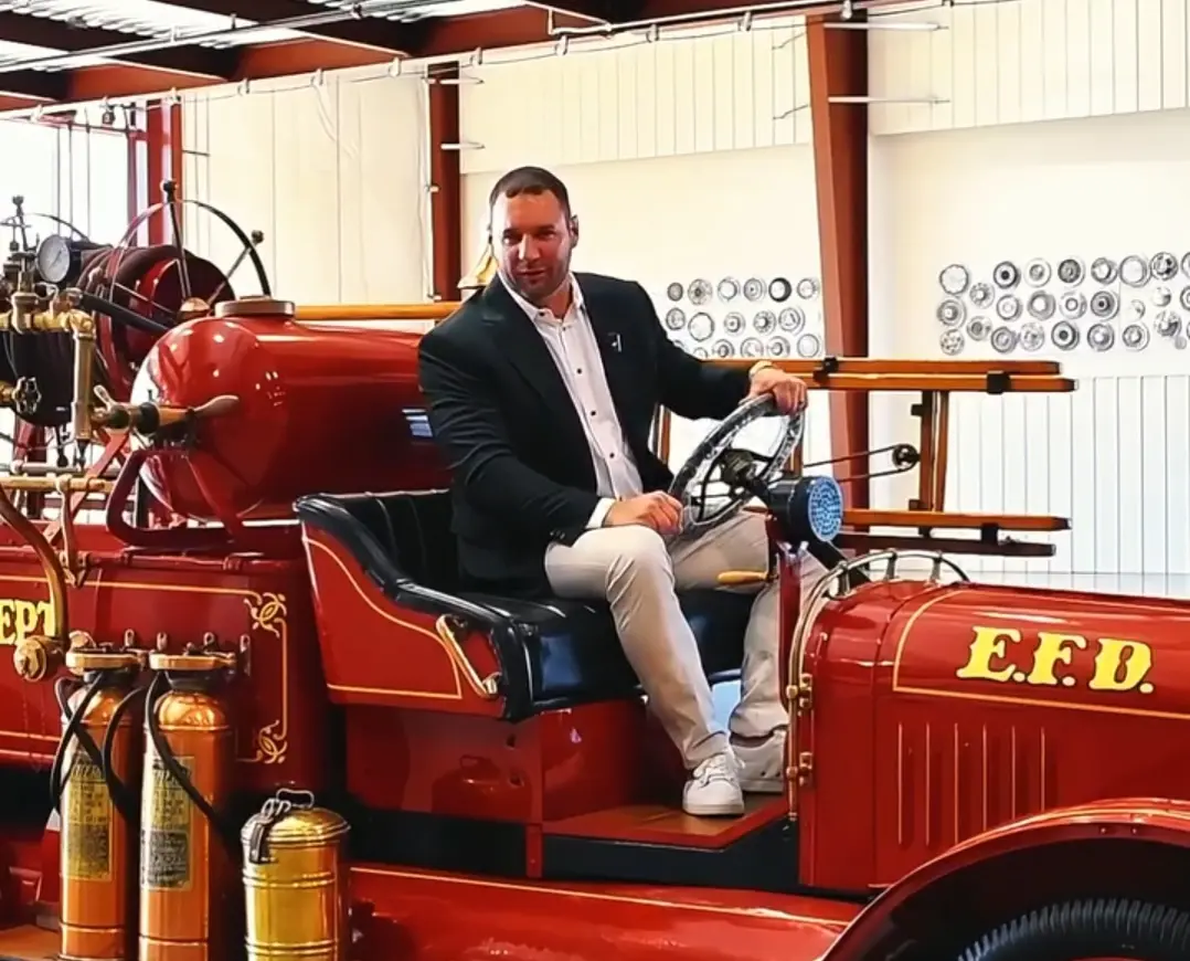 Robert Sears seated in a vintage fire engine